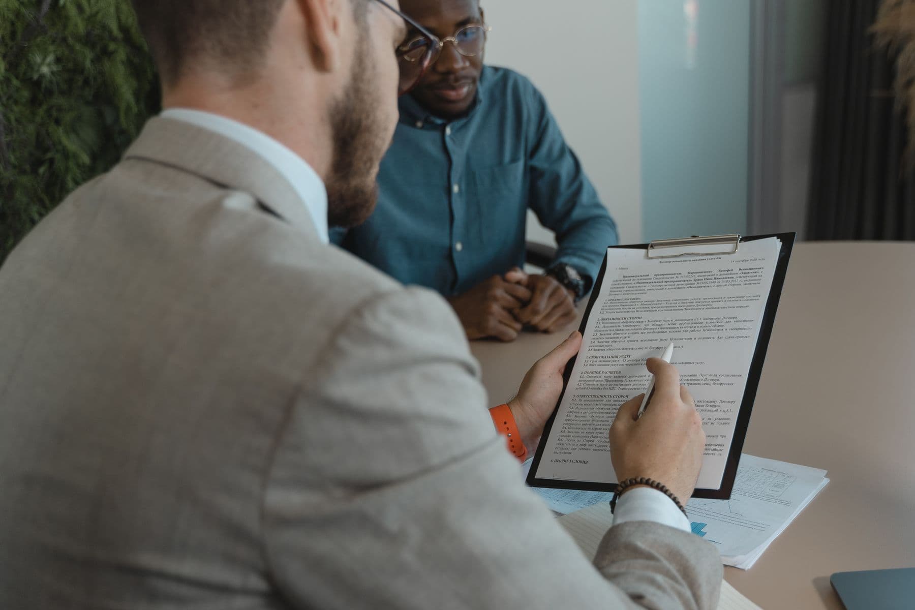 Two recruitment professionals reviewing a candidate document together